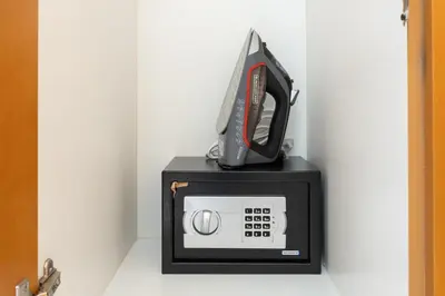a microwave with a phone on top of it at Greens Haven City & Golf View Balcony in Dubai