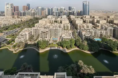 an aerial view of a city with buildings and a lake at Greens Haven City & Golf View Balcony in Dubai