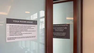 a glass door with a sign on it at Greens Haven City & Golf View Balcony in Dubai