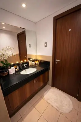 a bathroom with a sink and a large mirror at Cozy Studio in Downtown, Short walk to Burj Khalifa in Dubai