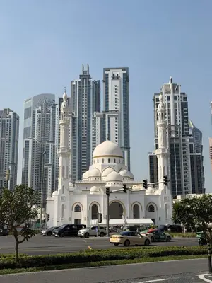 a white mosque in front of a large city at Cozy Studio in Downtown, Short walk to Burj Khalifa in Dubai
