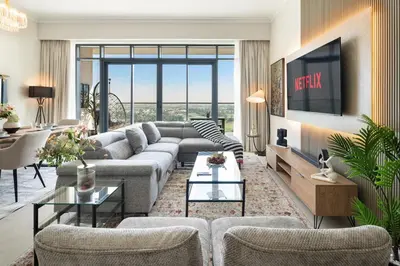 a living room with a couch and a tv at Rare 4BR Vida Golf & Pool View in Dubai