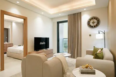 a living room with a couch and a bed and a television at Brand New 1-BR with Marina and JLT Balcony Views in Dubai