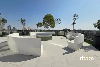two white benches sitting on top of a patio at Brand New 1-BR with Marina and JLT Balcony Views in Dubai
