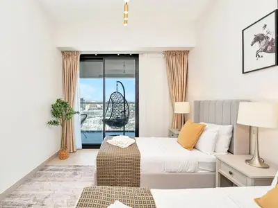 a hotel room with a bed and a balcony at Premium 2BD with Balcony Pool & Gym in Dubai