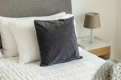 a black pillow sitting on top of a bed at Dubai Marina - Beautiful 2 Bedroom Apartment in Dubai