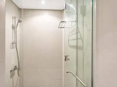 a shower with a glass door in a bathroom at Premium Studio Burj Khalifa & Canal View in Dubai