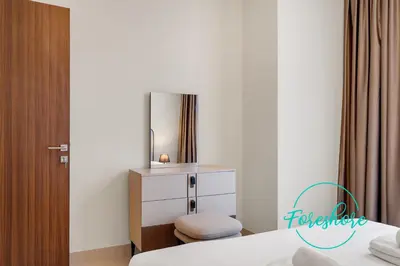 a bedroom with a bed and a dresser with a mirror at Ultra Luxury Villa 5BR With Maid Room in Dubai