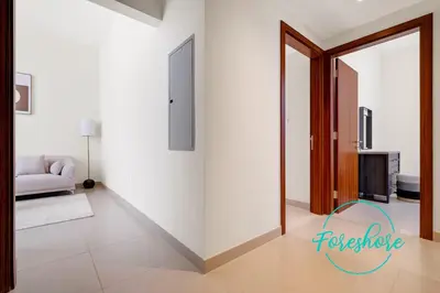 a living room with white walls and a mirror at Ultra Luxury Villa 5BR With Maid Room in Dubai