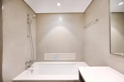 a bathroom with a bath tub and a shower at Golden Stays - Burj View Downtown Near Dubai Mall Sleeps 11 in Dubai