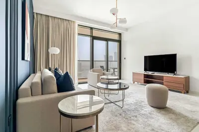 a living room with a couch and a tv at Silkhaus Luxurious 1BDR with Sea View in Emaar in Dubai