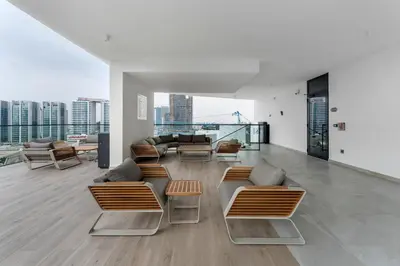 a living room with couches and chairs on a building at Arjan's Chic Studio with Cinema and Game Room in Dubai
