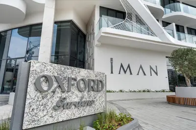 a sign in front of a building at Arjan's Chic Studio with Cinema and Game Room in Dubai