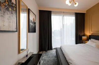 a hotel room with a bed and a large window at Forte 3BR Luxury PS5 Gaming Room Sleeps 9 in Dubai