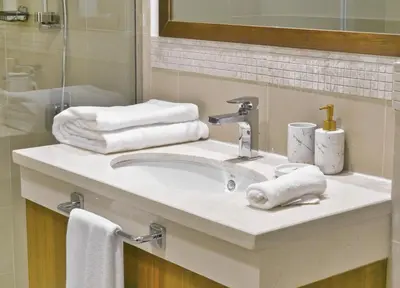 a bathroom with a sink with towels and a mirror at Burj VIsta 3 Bedroom - With spectacular Views in Dubai