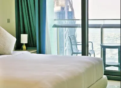 a bedroom with a bed and a large window at Burj VIsta 3 Bedroom - With spectacular Views in Dubai