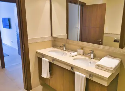 a bathroom with two sinks and a large mirror at Burj VIsta 3 Bedroom - With spectacular Views in Dubai