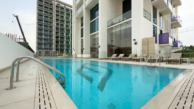 a swimming pool in the middle of a building at Binghatti House, JVC - 1 Bedroom Apartment - Allsopp & Allsopp in Dubai