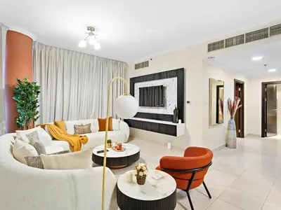 a living room with white furniture and orange chairs at Charming and Vibrant Living 1BDR In Marina Quay in Dubai