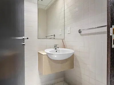 a bathroom with a sink and a mirror at Charming and Vibrant Living 1BDR In Marina Quay in Dubai