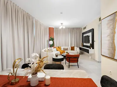 a living room with a couch and a table at Charming and Vibrant Living 1BDR In Marina Quay in Dubai