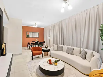 a living room with a couch and a table at Charming and Vibrant Living 1BDR In Marina Quay in Dubai