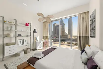 a bedroom with a large bed and a large window at VayK - Elegant Canal-Front 1 BD in a Prime Location in Dubai
