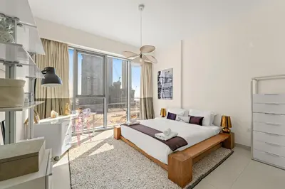 a bedroom with a bed and a large window at VayK - Elegant Canal-Front 1 BD in a Prime Location in Dubai