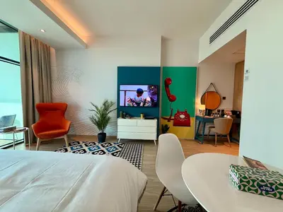 a bedroom with a bed and a tv in a room at The Sky in Dubai