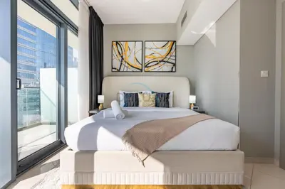 a bedroom with a large bed and a large window at High Floor Unit with Canal View, A Minutes Drive to Dubai Mall - Zada Tower, Business Bay by Deluxe Holiday Homes in Dubai