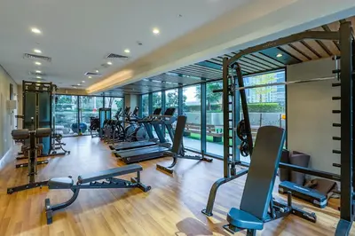 a gym with a bunch of treadmills and machines at High Floor Unit with Canal View, A Minutes Drive to Dubai Mall - Zada Tower, Business Bay by Deluxe Holiday Homes in Dubai