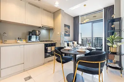 a kitchen and dining room with a table and chairs at High Floor Unit with Canal View, A Minutes Drive to Dubai Mall - Zada Tower, Business Bay by Deluxe Holiday Homes in Dubai