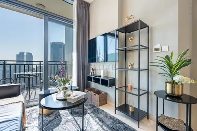 a living room with a view of the city at High Floor Unit with Canal View, A Minutes Drive to Dubai Mall - Zada Tower, Business Bay by Deluxe Holiday Homes in Dubai