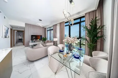 a living room with a glass table at Azizi Greenfield, Meydan Dubai in Dubai