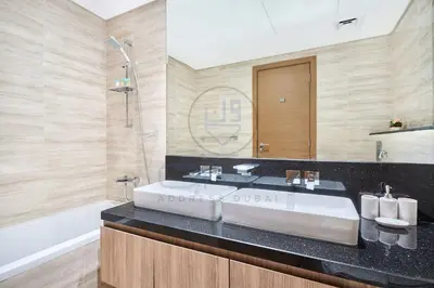 a bathroom with a large sink and a bath tub at Premium 2BR Apartment at Urban Oasis, Business Bay in Dubai