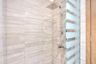 a shower with a glass door in a bathroom at Premium 2BR Apartment at Urban Oasis, Business Bay in Dubai