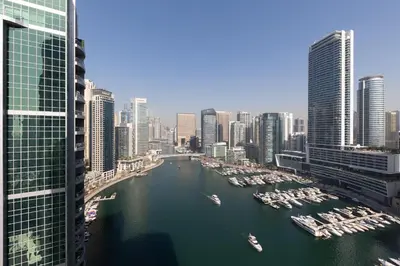 a view of a river in a city with boats at Bright 2BR Marina View with Balcony in Dubai