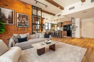 a living room with a couch and a table at Luxurious Newly Furnished 2 Bed in Dubai Marina in Dubai