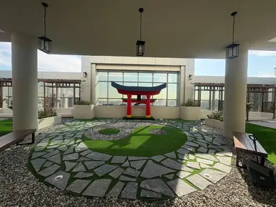 a courtyard with a red gate in a building at Frank Porter - Adhara Star in Dubai