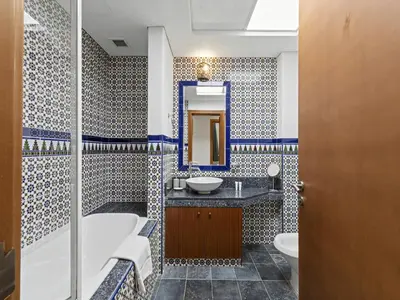 a bathroom with a tub sink and a mirror at DVH Al Basri Palm Beachfront 2BR Full Sea Views in Dubai