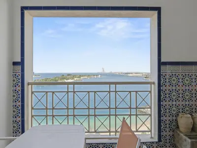 a view of the ocean from a window at DVH Al Basri Palm Beachfront 2BR Full Sea Views in Dubai