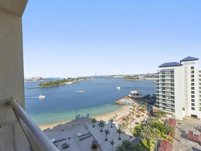 a view from a balcony of a beach and buildings at DVH Al Basri Palm Beachfront 2BR Full Sea Views in Dubai