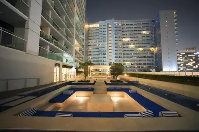 a swimming pool in a city at night at Luxury 2BR in Business Bay Close to Dubai Mall in Dubai