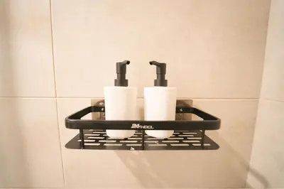 a shelf with toilet paper and two cups on it at Luxury 2BR in Business Bay Close to Dubai Mall in Dubai