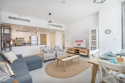 a living room with a couch and a table at StayShort - Cozy 2 Bedroom Retreat in Dubai South Close to Expo 2020 in Dubai Marina