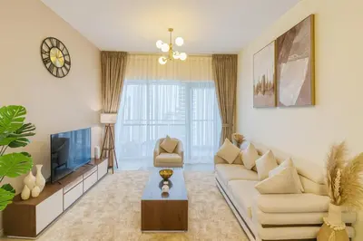 a living room with a couch and a tv at Deluxe Apartments Near WTC and Sheikh Zayed in Dubai