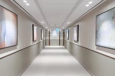 a hallway of an art gallery with paintings on the walls at Brand New 1BR - Burj View - Infinity Pool - Dubai Mall in Dubai