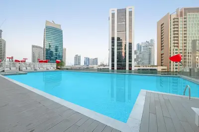a large swimming pool on the roof of a building at Chic Studio Steps to Dubai Mall with Infinity Pool in Dubai