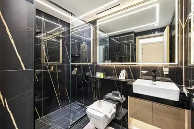 a bathroom with a white toilet and a sink at Stylish 1-Bedroom Apartment in JVC Dubai in Dubai