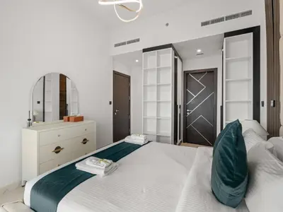 a bedroom with a large white bed and a mirror at Opalz Serenity Designer- 1BDR Retreat-07 in Dubai